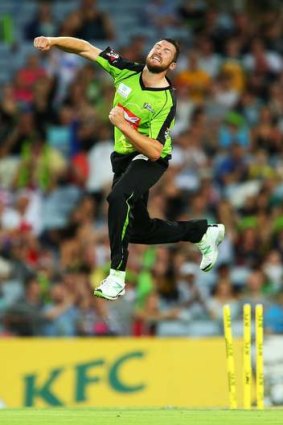 Flying high: Luke Feldman celebrates taking a wicket for the Thunder.