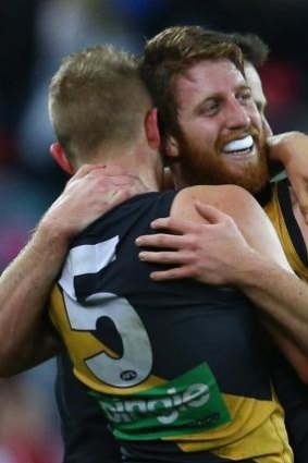 The Tigers celebrate their unlikely victory over the Swans.