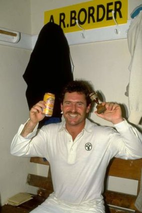 Captain Allan Border holds up the Ashes in the dressing room in 1989.