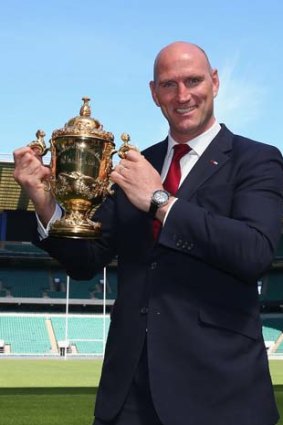 England Rugby 2015 ambassador Lawrence Dallaglio holds the Webb Ellis Cup during the announcement of the schedule for the 2015 Rugby World Cup at Twickenham Stadium on Thursday.