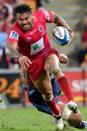 Red peril: Queensland winger Digby Ioane makes a bust against the Force on Saturday night.