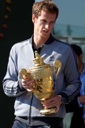 Andy Murray poses with the 2013 Wimbledon trophy at the All England Club in Wimbledon on Monday.