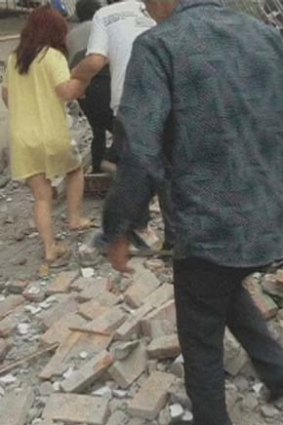 People walk on rubble after a the earthquake.
