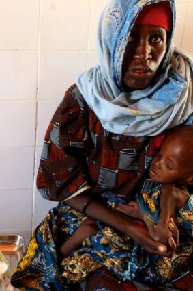 Mariama Awa cradles her son Malla as they sit and wait in a relief centre in Maine Soroa, in the remote south-east corner of Niger.