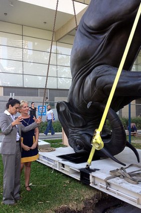 GoMA acting director Suhanya Raffel and Arts Minister Ros Bates inspect the sculpture The World Turns.