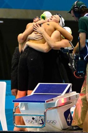 Australia's victorious 4x100m freestyle relay team - Cate Campbell, Alicia Coutts, Melanie Schlanger and Brittany Elmslie - embrace after touching first to take the Olympic gold medal.