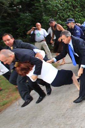 Not quite Cinderella ... Julia Gillard evades protesters.