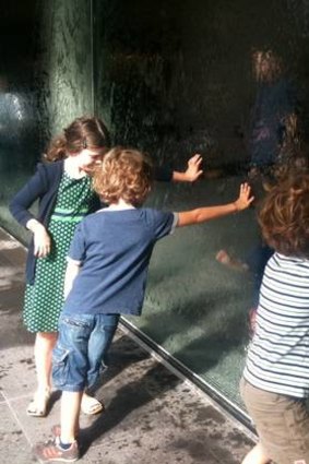 Mark Healy's children touch the NGV's waterwall.