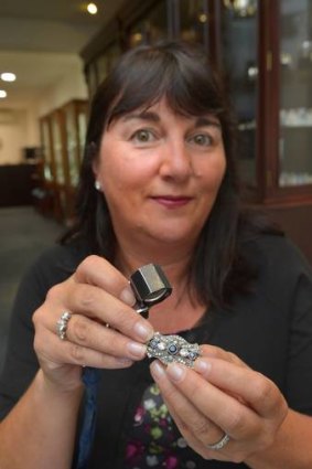 Mandy Catanach inspects a piece of pre-loved jewellery.