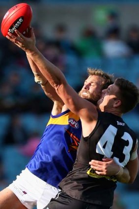 Full stretch: Eagle Will Schofield and Port's Daniel Stewart contest for the ball yesterday.