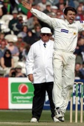 Pakistan's Saqlain Mushtaq gets the wicket of England's Andrew Caddick during the final day of the second Test at Old Trafford on June 4, 2001.