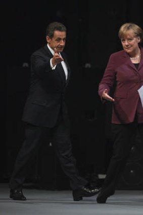 Angela Merkel and Nicolas Sarkozy arrive for a news conference ahead of the Group of 20 Summit  in Cannes.