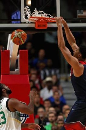 Fearsome: Anthony Davis rattles the rim for the US against Brazil.