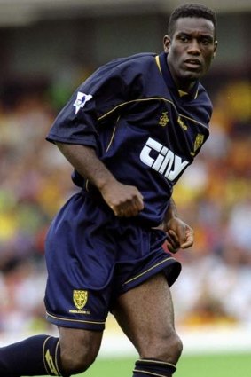 Sacked .. Robbie Earle, seen here playing for Wimbledon