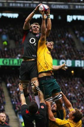 Tom Croft (L) of England claims the ball next to Rocky Elsom of Australia in the lineout.