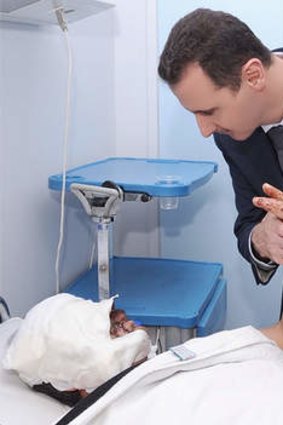 President Bashar Assad visits a patient at a military hospital in Damascus, Syria in 2012. Assad has embraced every tool at his disposal including social media to project confidence to dedicated fans.