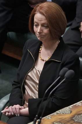 Julia Gillard listens to Mr Abbott's attack.