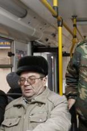 Alert: A Cossack patrols a bus in central Volgograd. Authorities are said to suspect ethnic Russian converts to Islam may be behind the suicide bombings.
