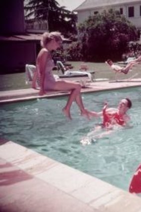A dream-like domesticity is captured in this photograph of a pool party in 1950s California.