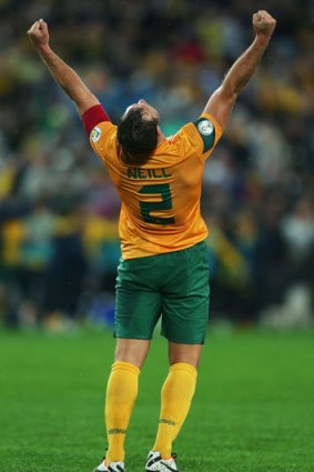 At a stretch: Socceroos skipper Lucas Neill celebrates qualifying for next year’s World Cup after beating Iraq in June.