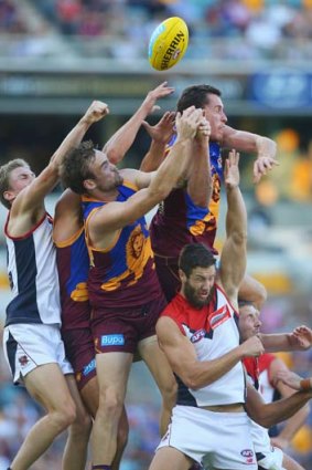 Hands up: A big pack contests a marking contest at the Gabba on Sunday.