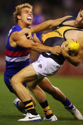 Captain courageous: Trent Cotchin takes a one-handed mark against Bulldog Mitch Wallis.