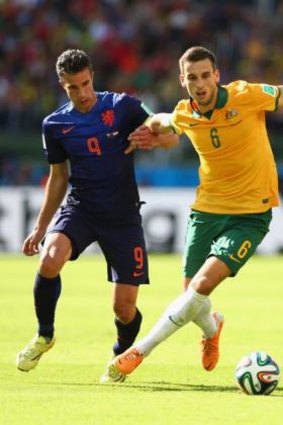 World Cup duty ... Matthew Spiranovic in action for the Socceroos against Dutch veteran Robin van Persie in Brazil.