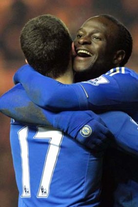 Chelsea's Victor Moses (R) celebrates scoring the second goal with teammate Eden Hazard.