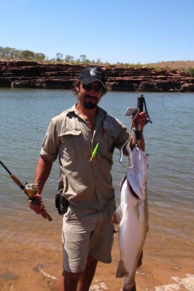 Fishing guide Tom with a catch from the Durack river.