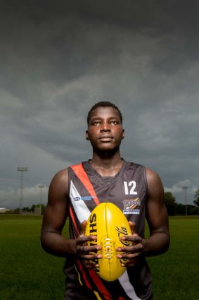 Kicking on: Sudanese refugee Patrick Taban now plays for the NT Thunder Under-18s AFL side.