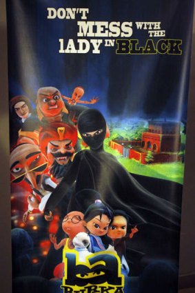 A poster of animated Burka Avenger series is displayed at an office in Islamabad, Pakistan.