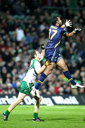 Adam Goodes, who kicked four three-point overs, marks in front of Irelands's Brendan Donaghy during the first Test in Limerick.