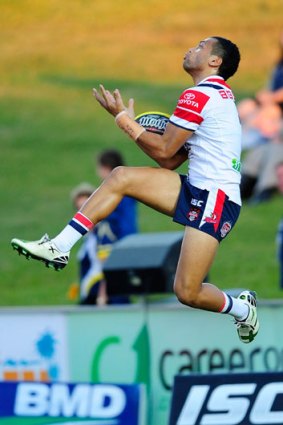 Alofa Alofa catches a high ball for the Roosters.