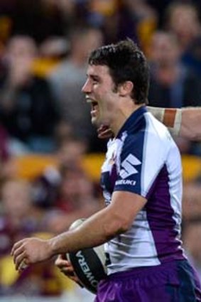 Late score: Storm halfback Cooper Cronk (left) celebrates with Ryan Hinchcliffe after kicking a winning field goal last night.