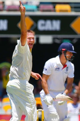 Australian bowler Ryan Harris claims the wicket of England captain Alastair Cook.