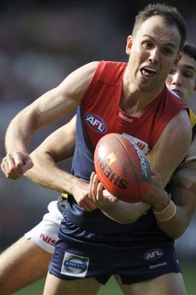 Melbourne's Cameron Bruce is tackled by Richmond's Shane Edwards.