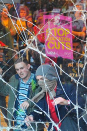 Demonstrating students clashed with police and broke windows at the headquarters of the Conservative Party in London.