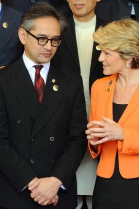 Grin and bear it: Foreign ministers Marty Natalegawa and Julia Bishop at the opening of the Bali Democracy Forum in Bali on Thursday.