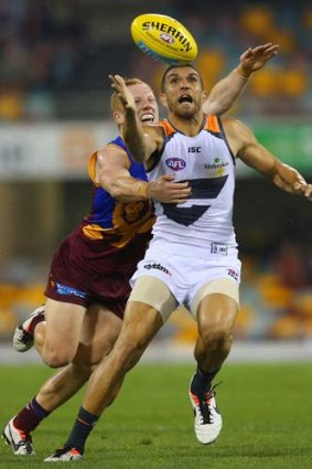 Easy does it: Brisbane's Josh Green (left) tries to hold back Curtly Hampton.