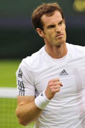 Flying the flag: Britain's Andy Murray downs Spain's Tommy Robredo in the third round at Wimbledon.