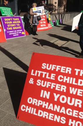 Protesters gather outside the public hearing.