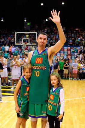 Townsville veteran Russell Hinder waves to the crowd with his children in his last home game before retirement.