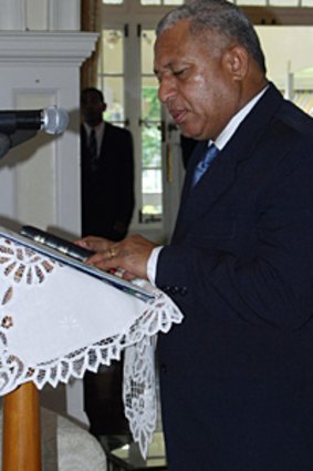 Commodore Frank Bainimarama  is sworn in as interim prime minister at Government House in Suva on Saturday.