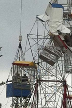 People await rescue after the ultra-light plane crashed into a ferris wheel at the country fair near Taree.