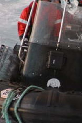 Sea Shepherd activists try to sever a wire towed by blockading Japanese harpoon ship Yushin Maru.