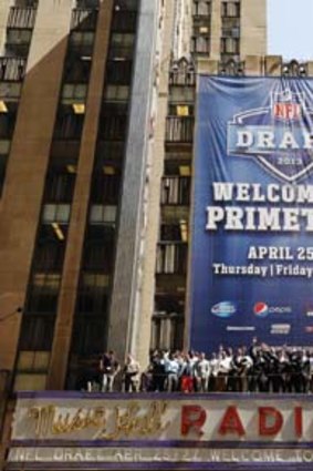 NFL Draft prospects stand on the marquee above Radio City Music Hall.