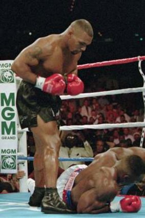 No mercy: Heavyweight champ Mike Tyson stands over  Bruce Seldon after decking him in the first round of their bout in 1996.