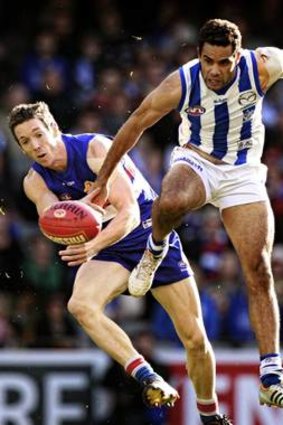 Coming through: North Melbourne's Daniel Wells leads Robert Murphy to the ball.