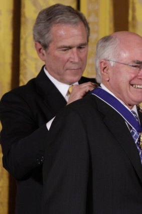 Right behind his mate: President Bush awards the Medal of Freedom to John Howard.