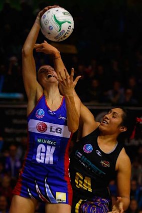 Julianna Naoupu of the Magic tries to block Anna Harrison of the Mystics.